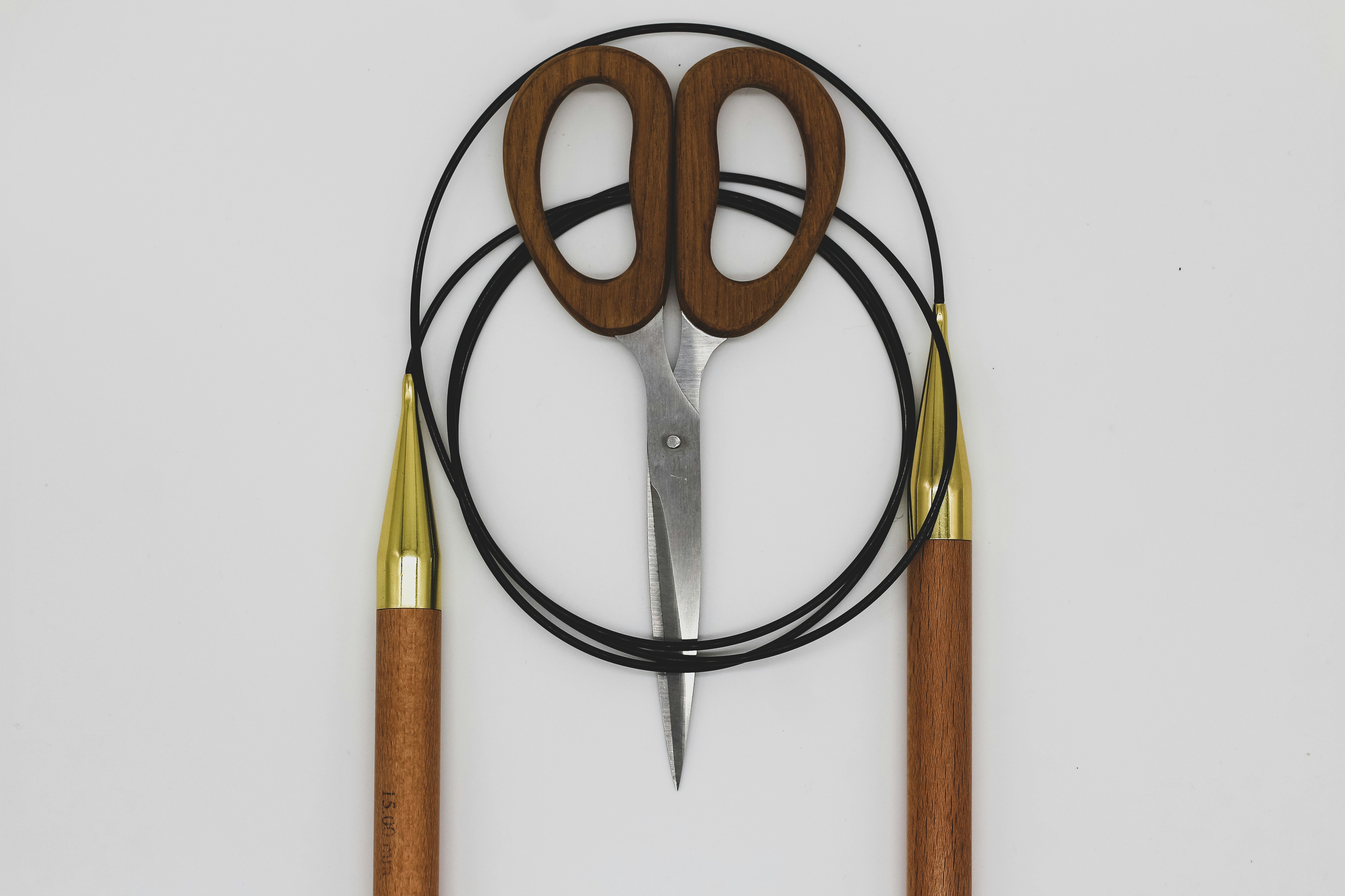 a pair of scissors sitting on top of a wooden handle