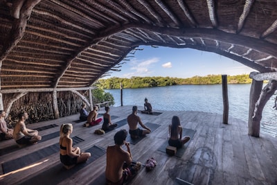 a group of people sitting on top of a wooden floor