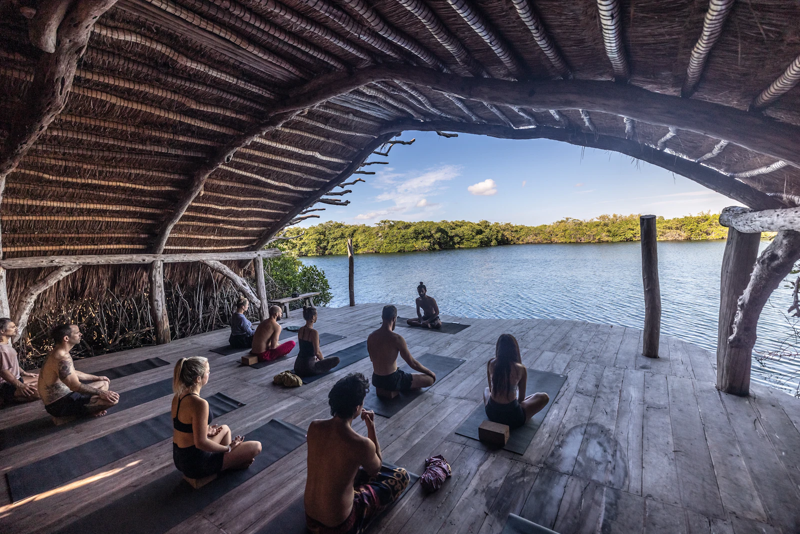 Students seated on a wooden floor during a meditation session