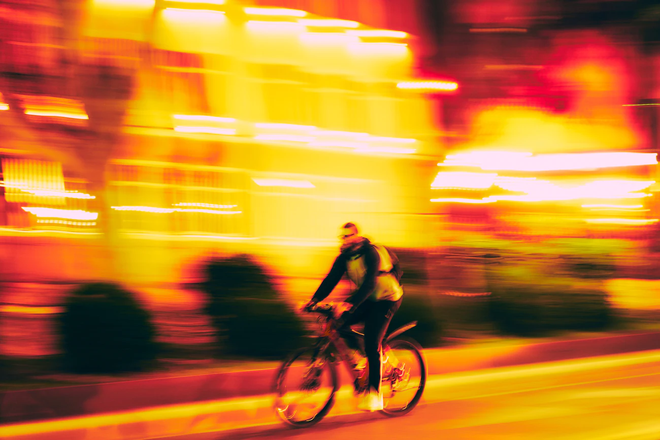 Urban cyclist moving through a city environment during an evening ride