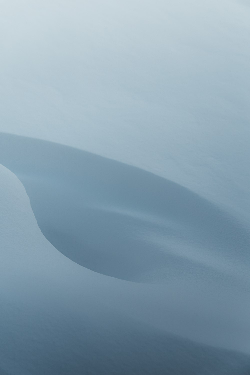 a large body of water surrounded by snow