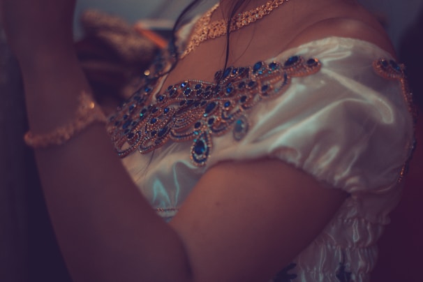 A stylish blouse paired with elegant accessories, perfect for a special occasion.