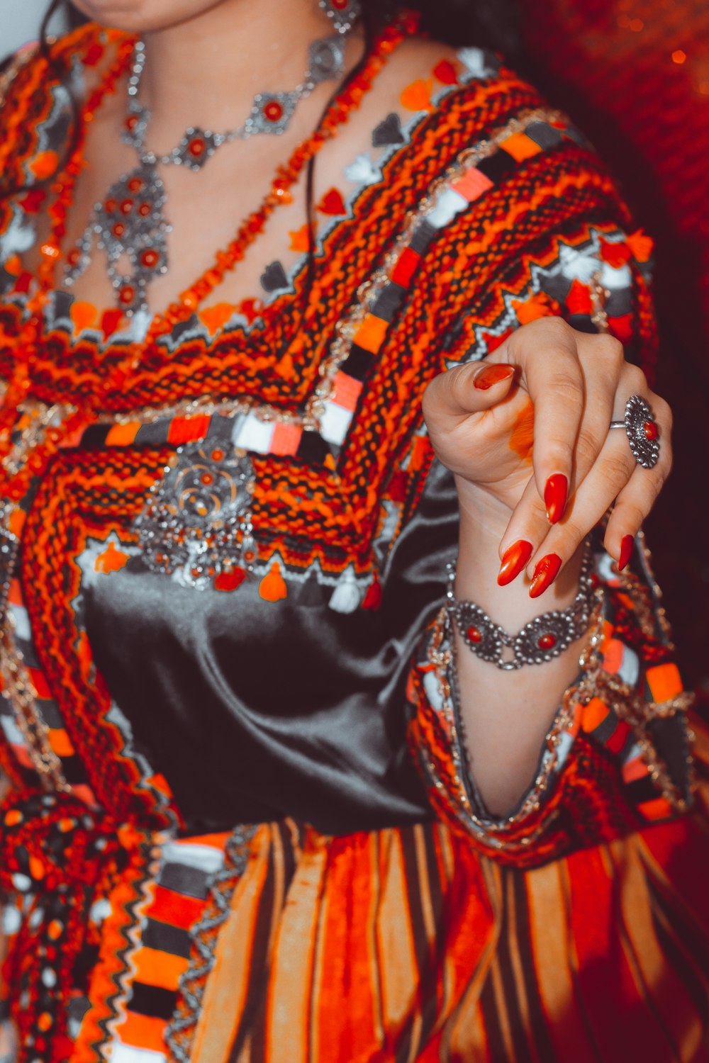 a woman in a colorful dress holding a cell phone