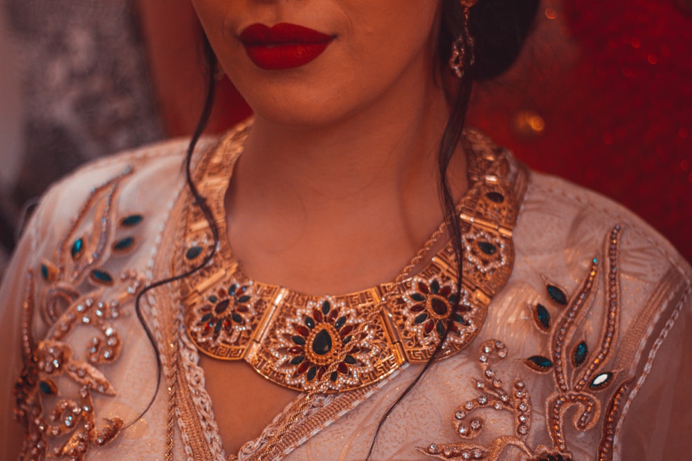 a woman wearing a necklace and earrings