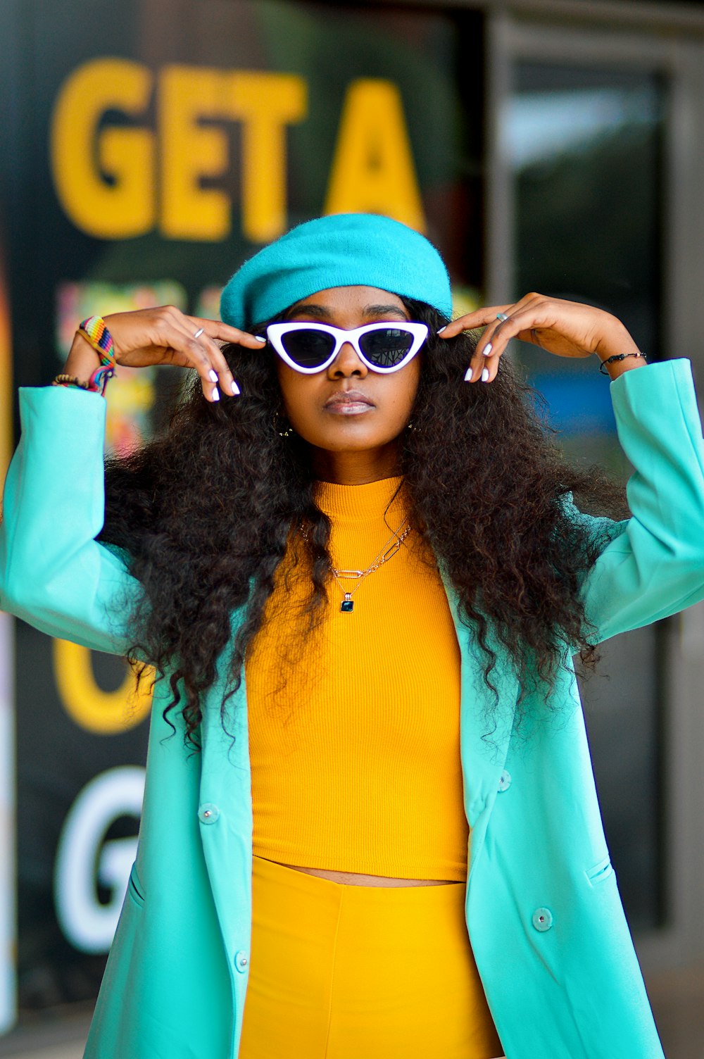 a woman in a yellow top and blue jacket