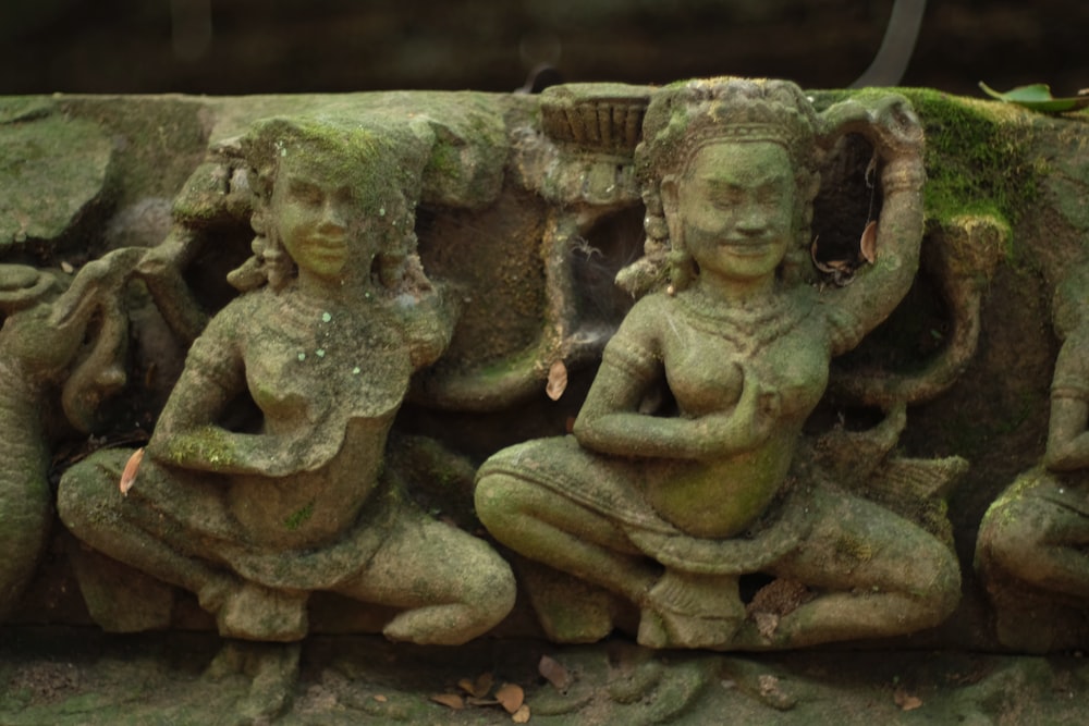 a statue of a woman and a man sitting next to each other