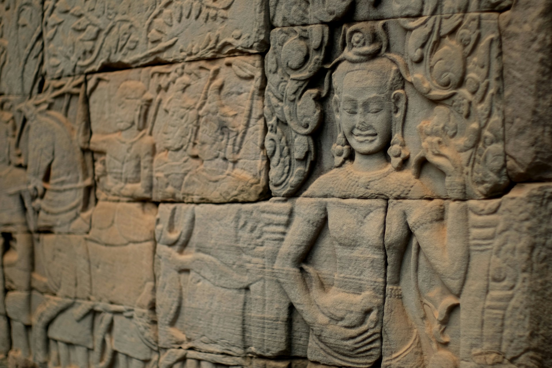 a close up of a stone wall with carvings on it
