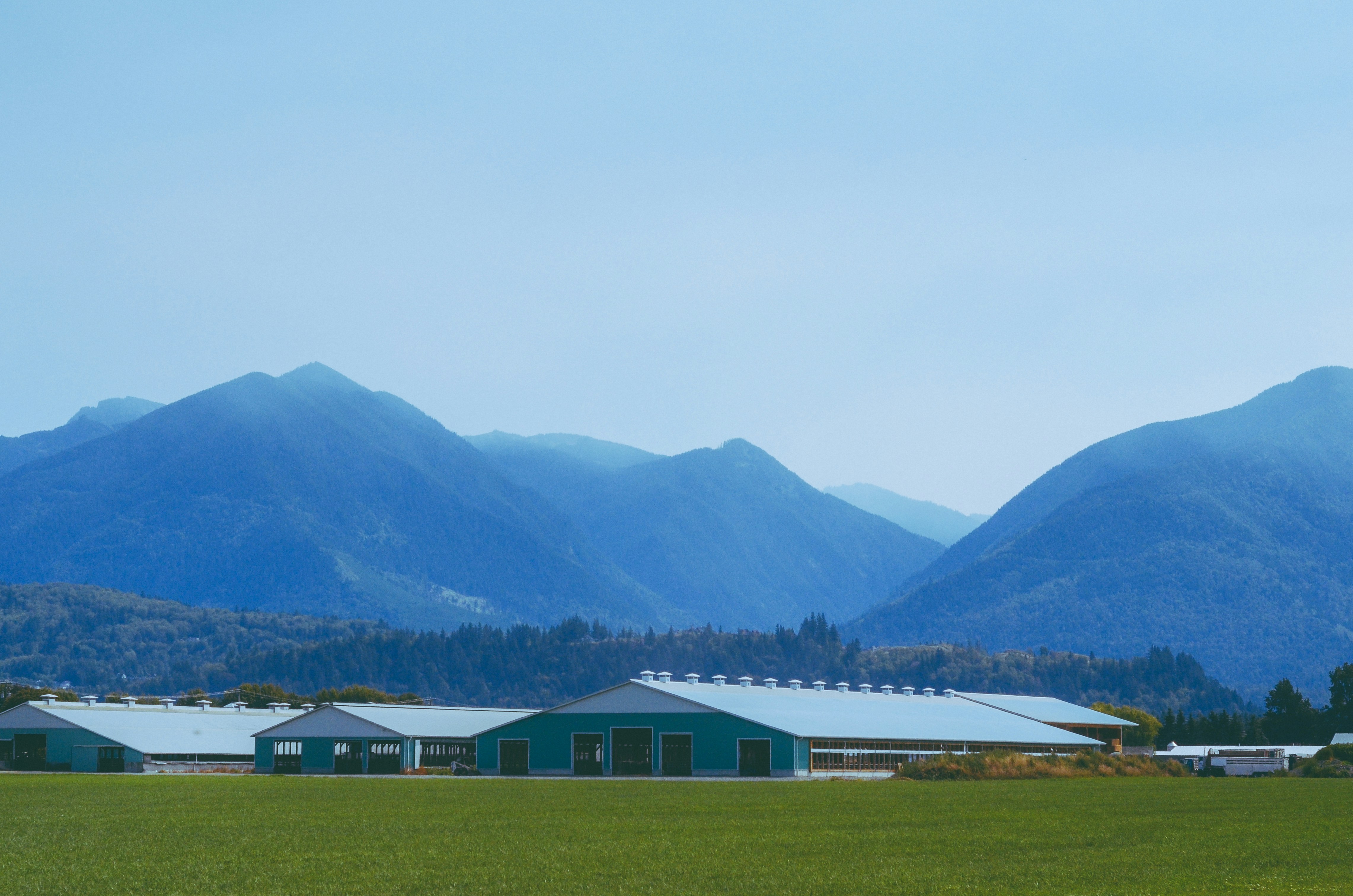 a farm with mountains in the background