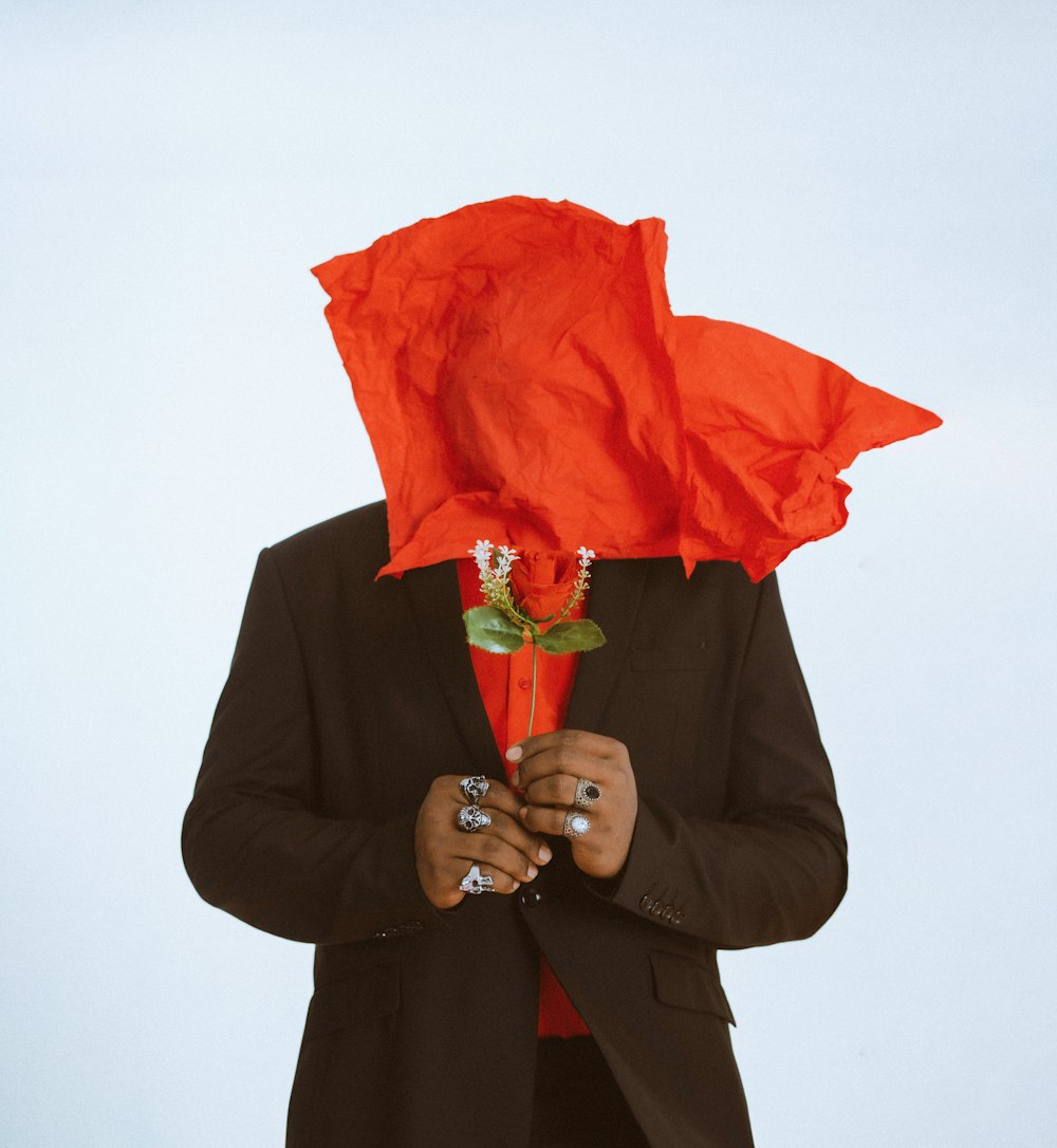 a person with a red umbrella over their head