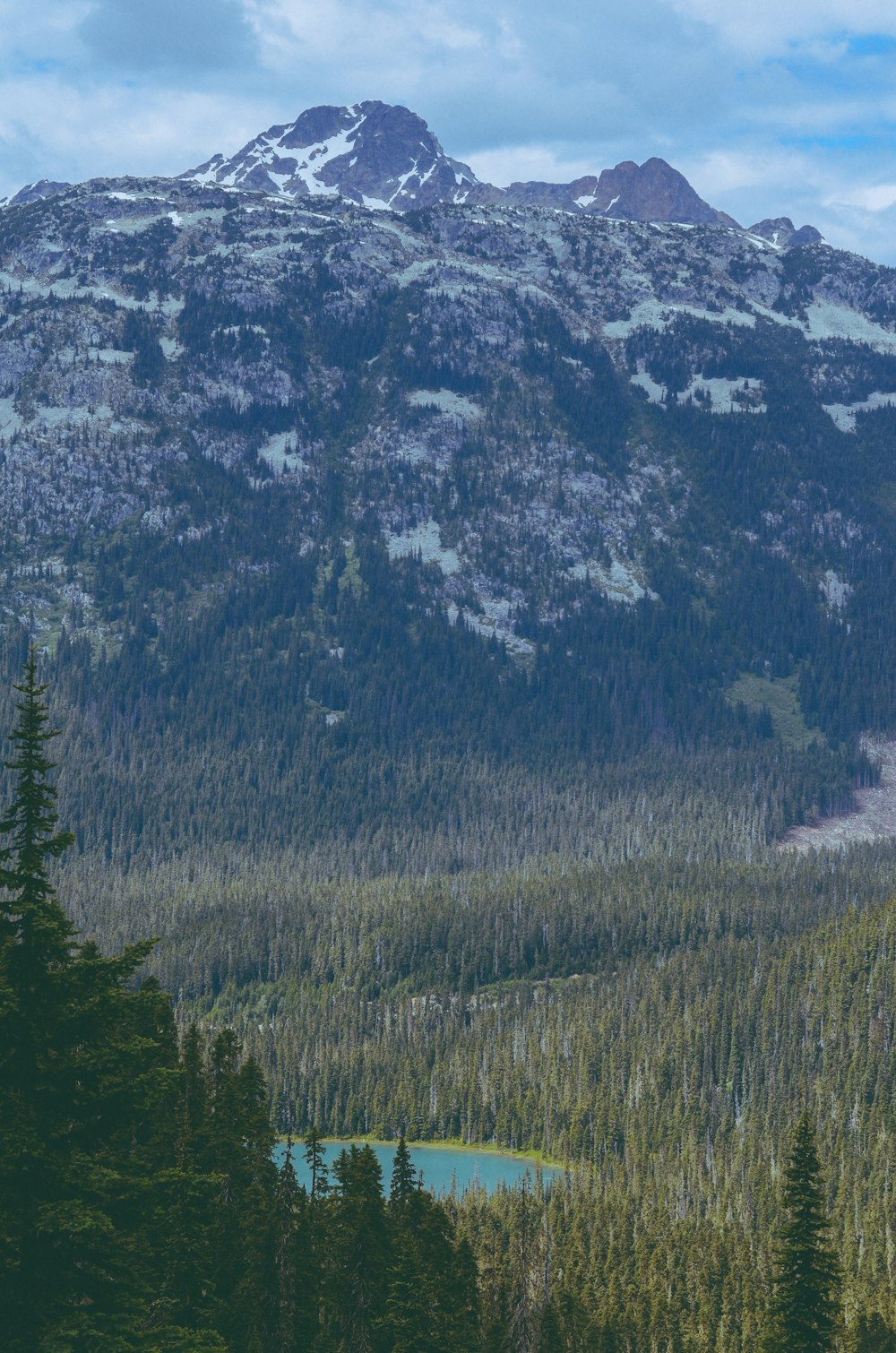 a view of a mountain range with a lake in the foreground