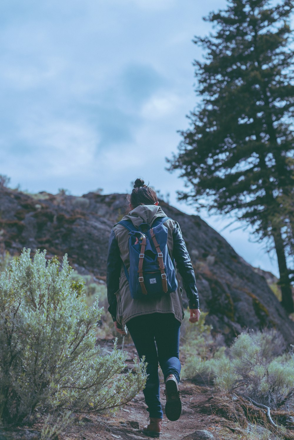 a person with a backpack walking on a trail