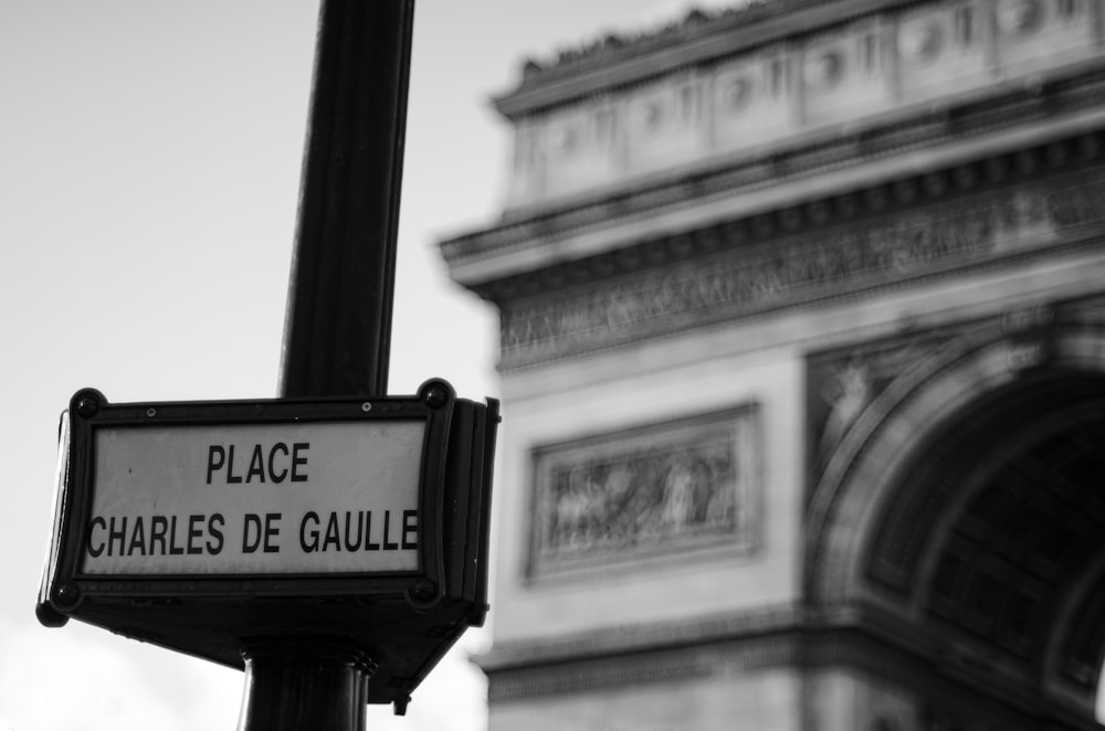 a black and white photo of a street sign