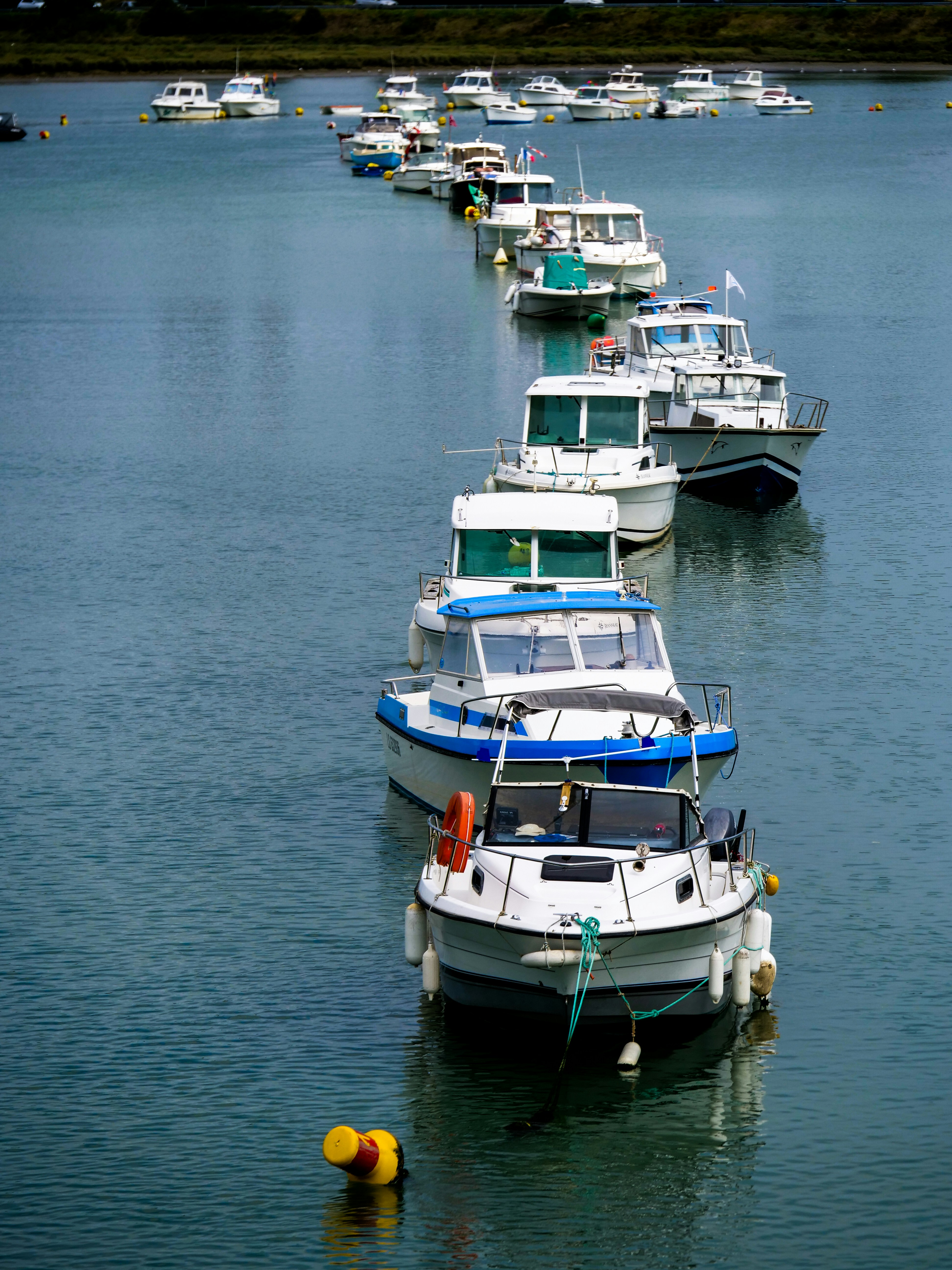 a row of boats floating on top of a body of water