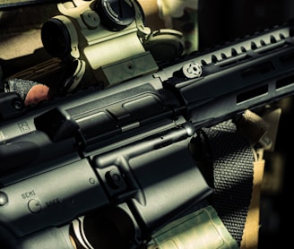 a close up of a gun with a flag in the background