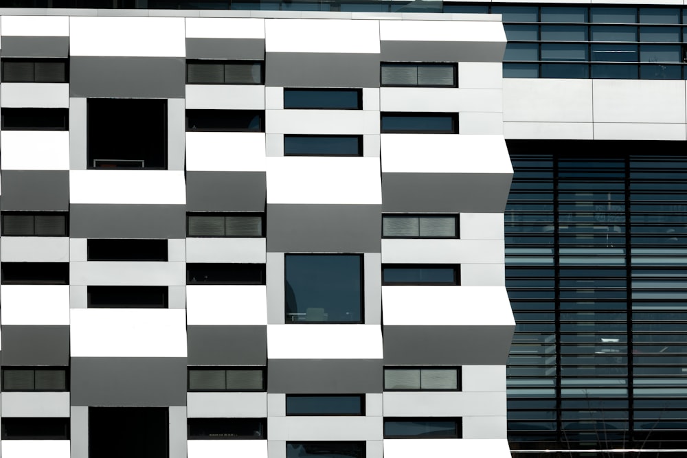 a large white and black building with windows