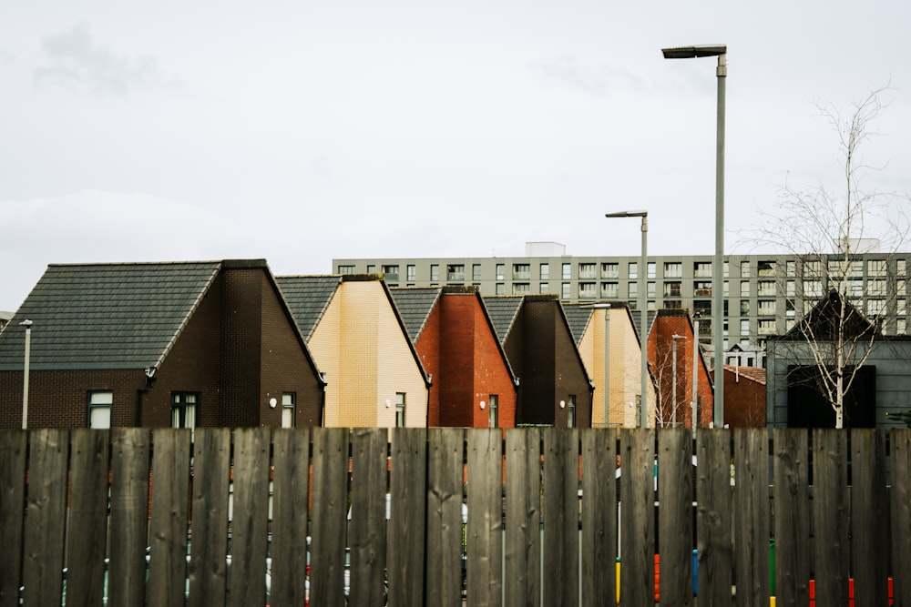 a row of houses next to a wooden fence