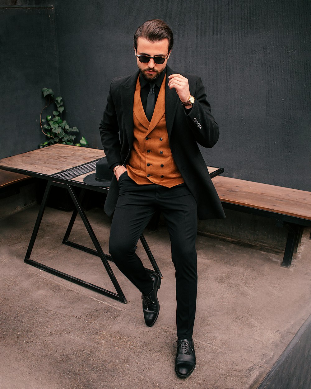 a man in a suit and tie sitting on a bench