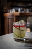 a drink with a slice of cucumber in it
