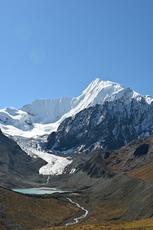 a snow covered mountain with a river running through it