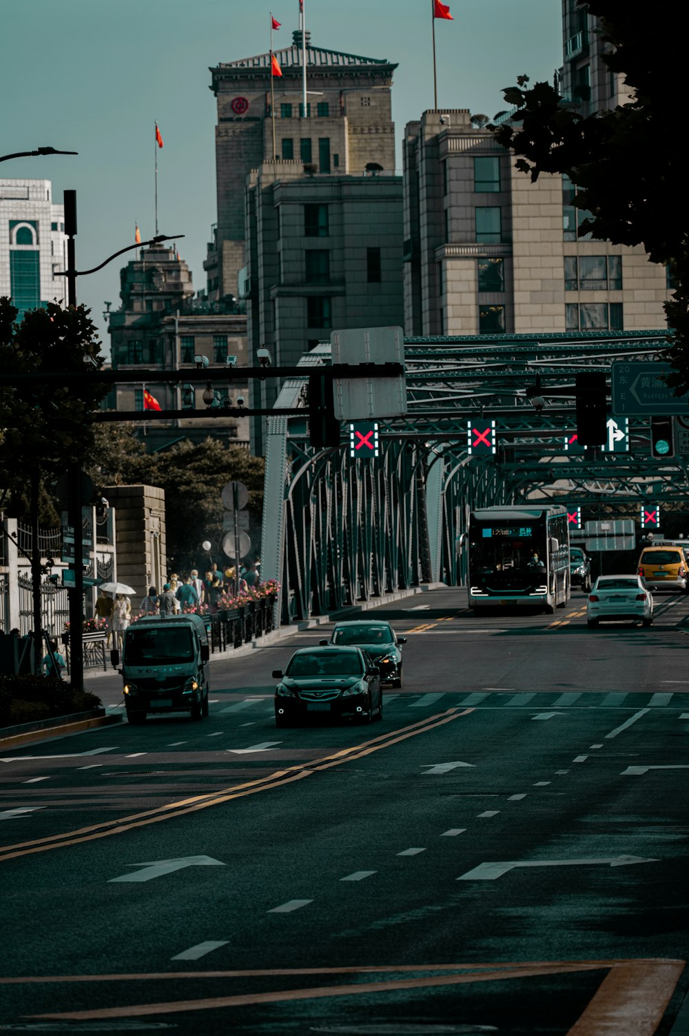 a city street filled with traffic next to tall buildings