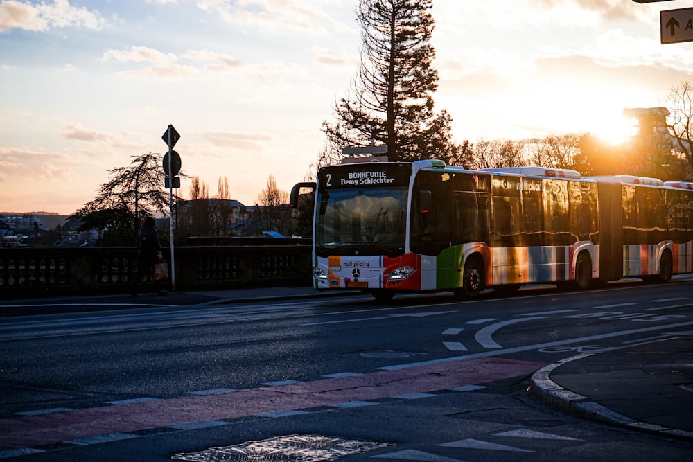 a bus driving down a street next to a traffic light