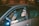 a man sitting in a car with his head out the window