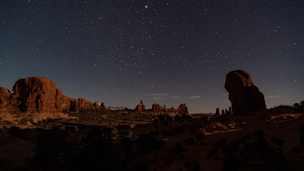 the night sky with stars above a desert landscape