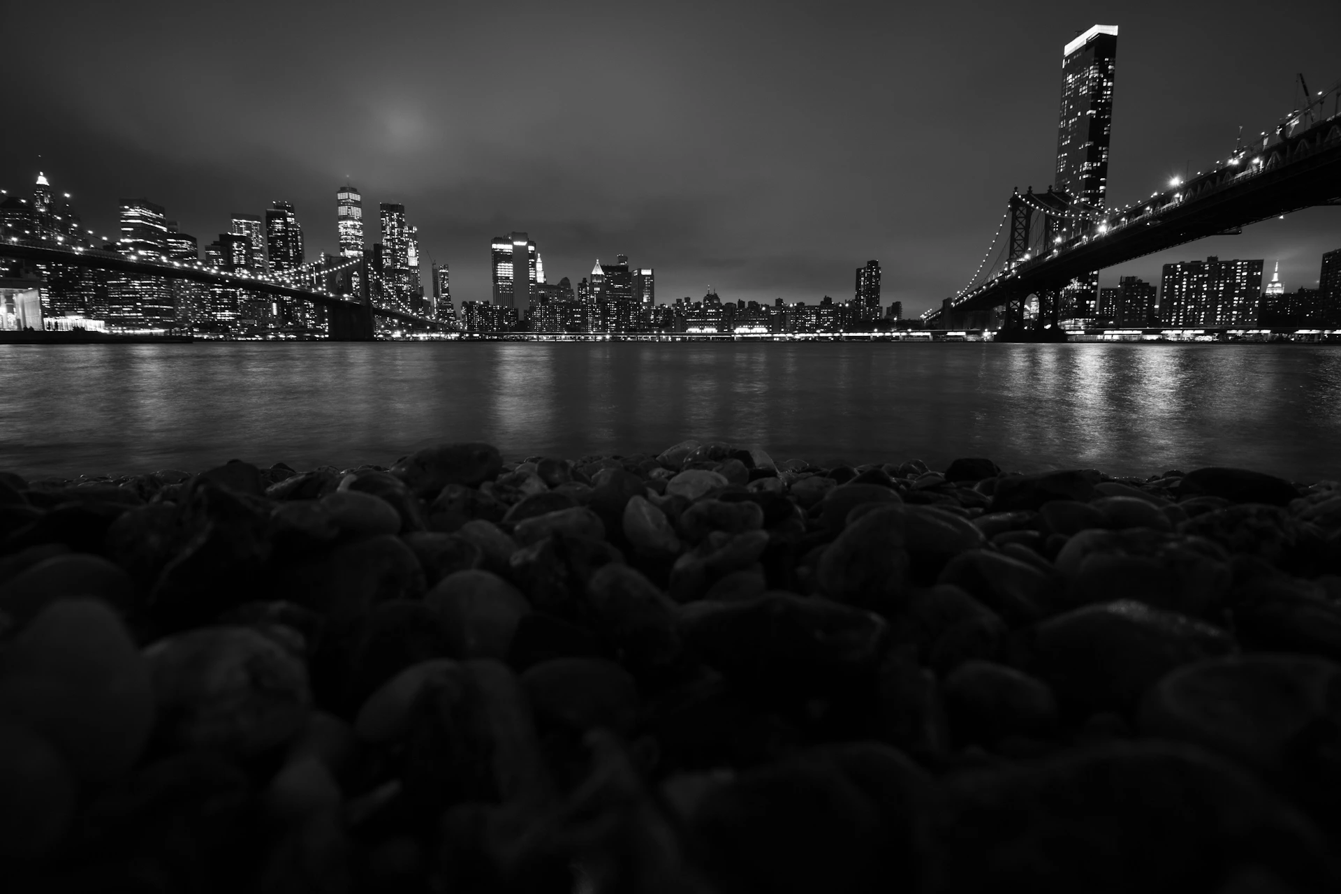 a black and white photo of a city at night
