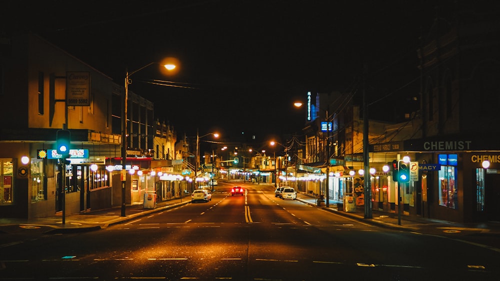 a city street at night with traffic lights