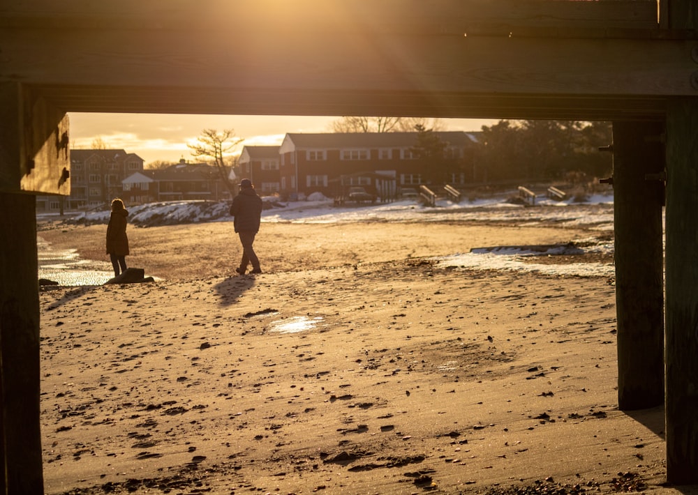 a man and a child are walking on the beach