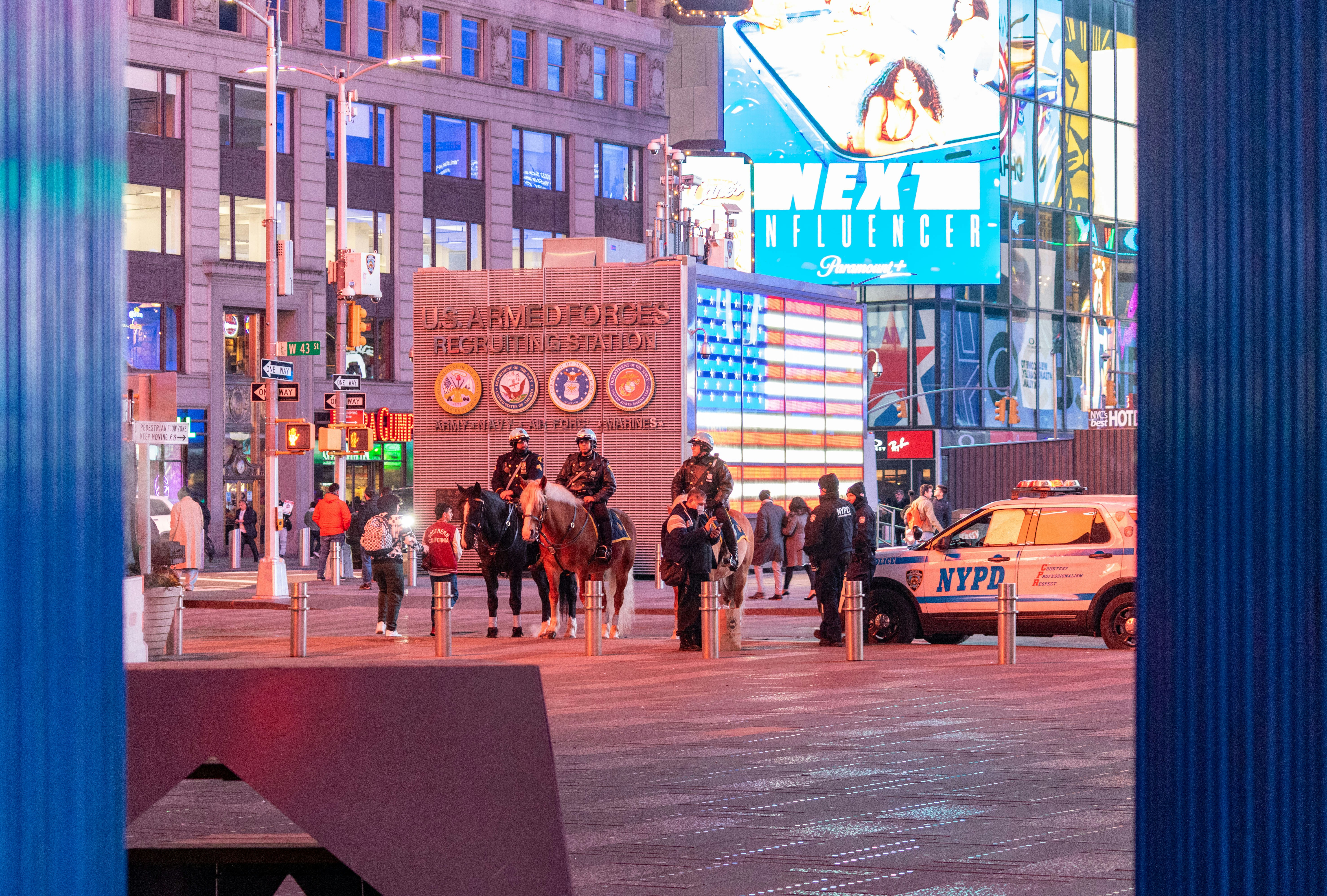 a group of people riding horses down a street