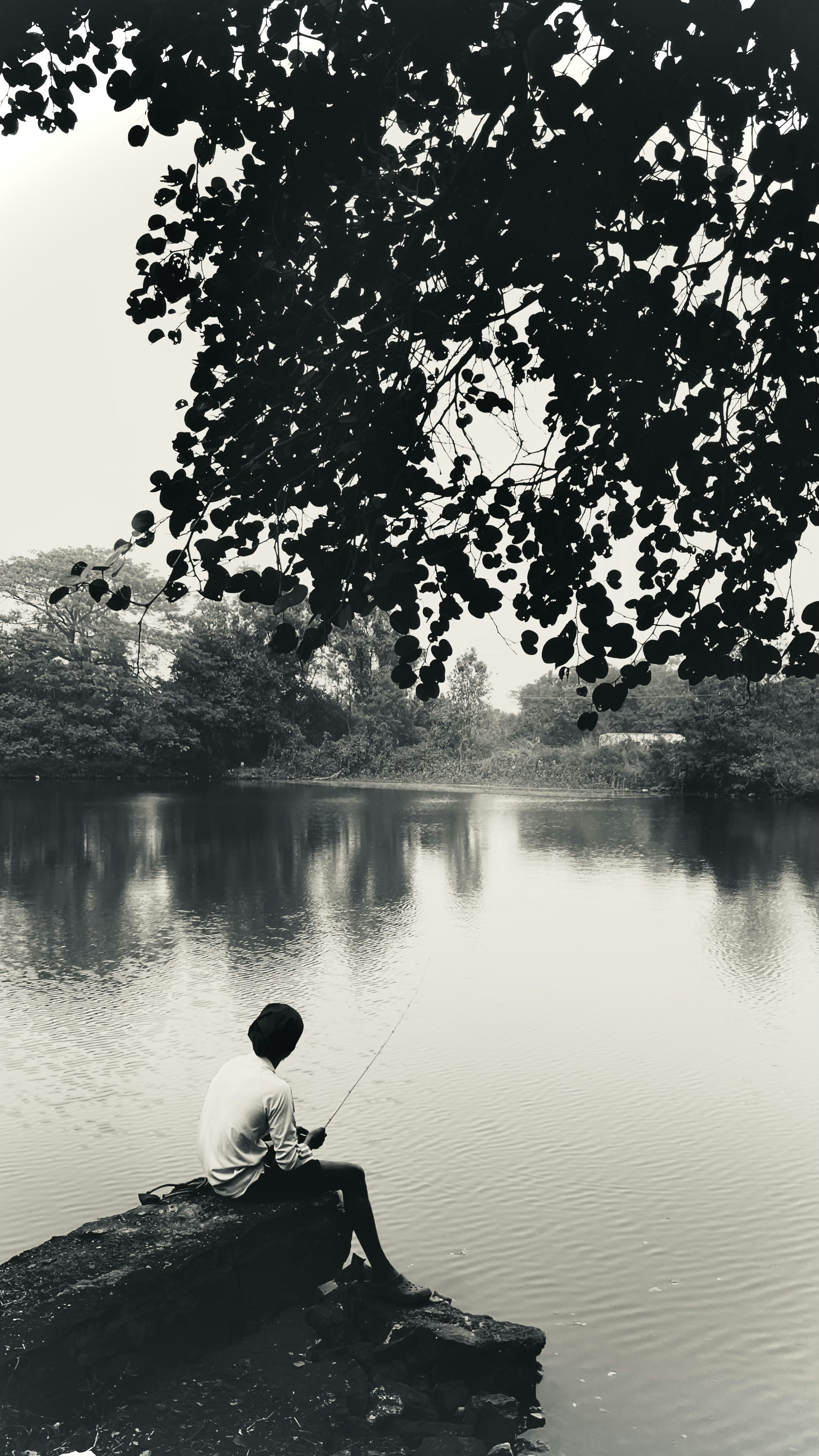 Person reflecting in nature with a serene expression