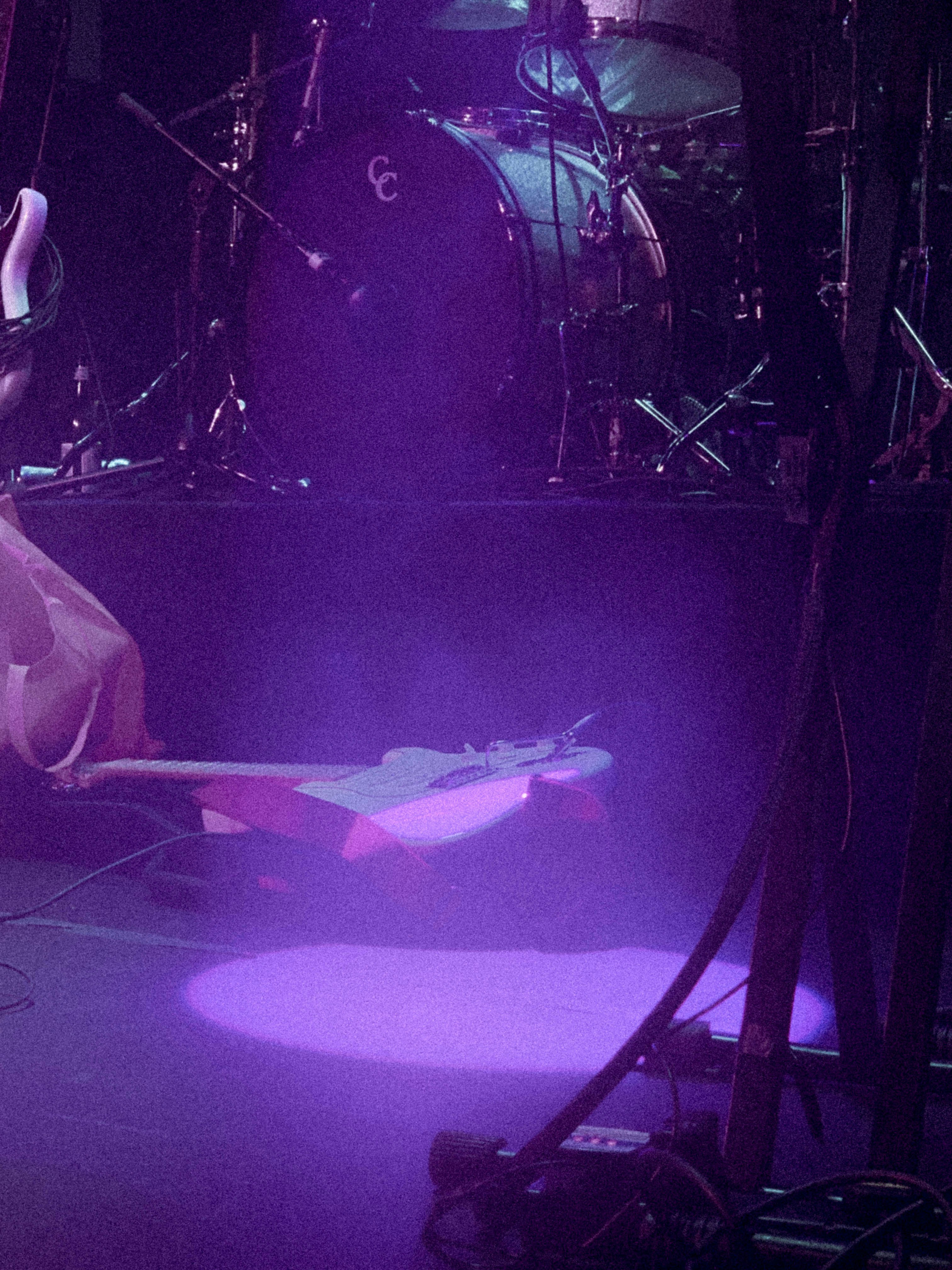a person sitting on a stage with a microphone