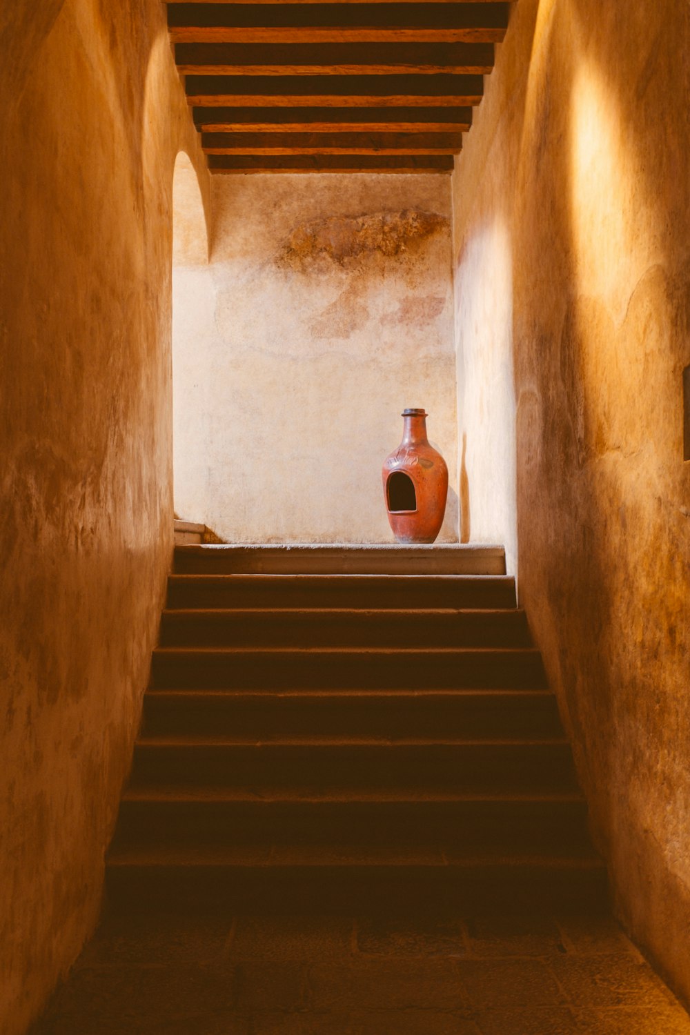 a vase sitting on top of a set of stairs