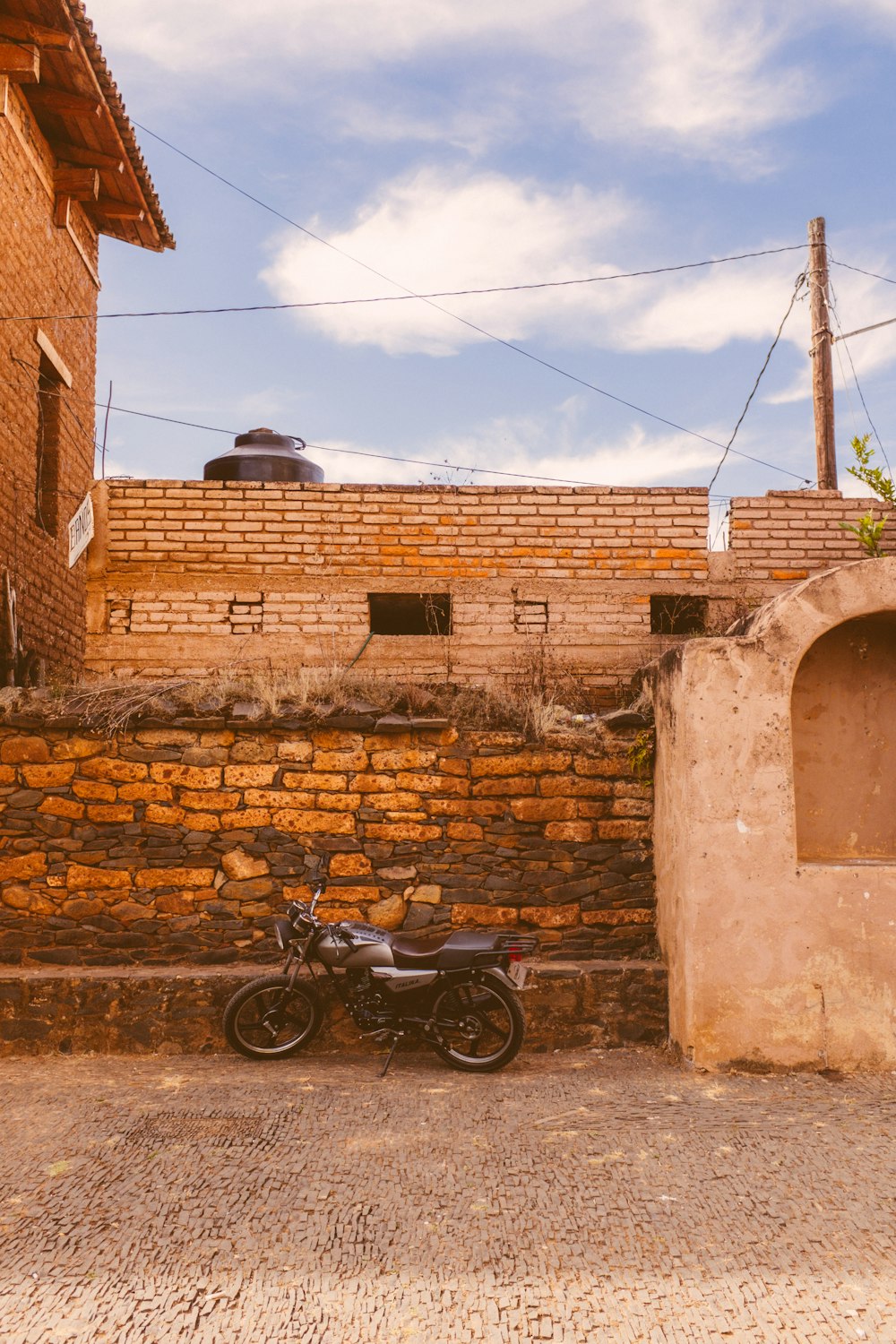 a motorcycle parked in front of a brick building