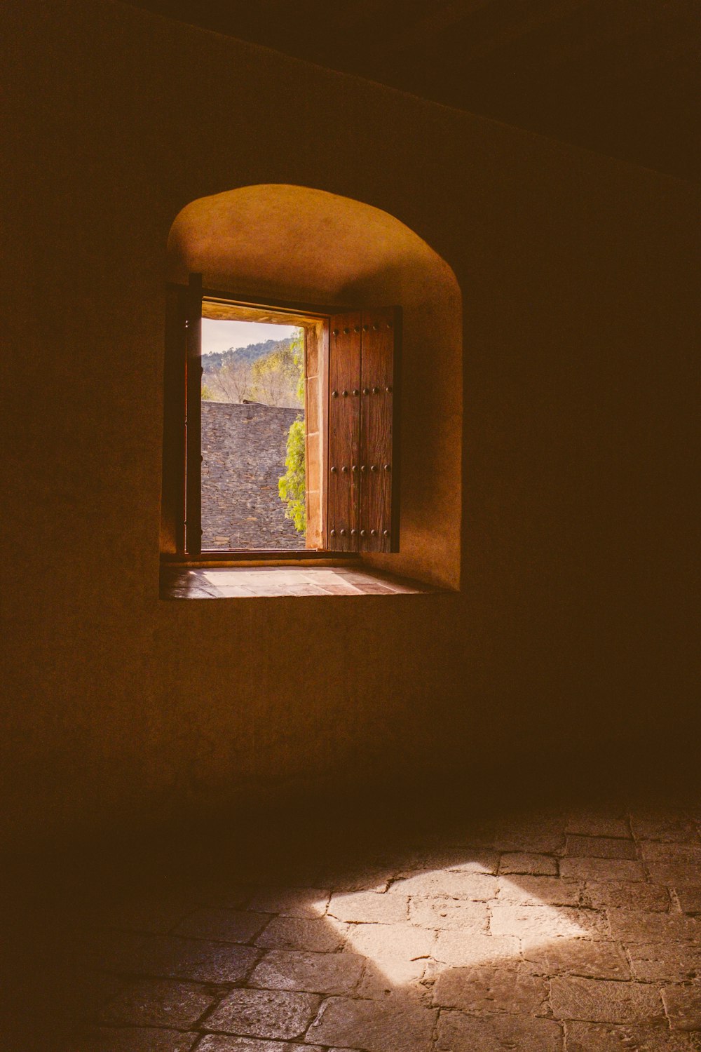 an open window with a view of a mountain