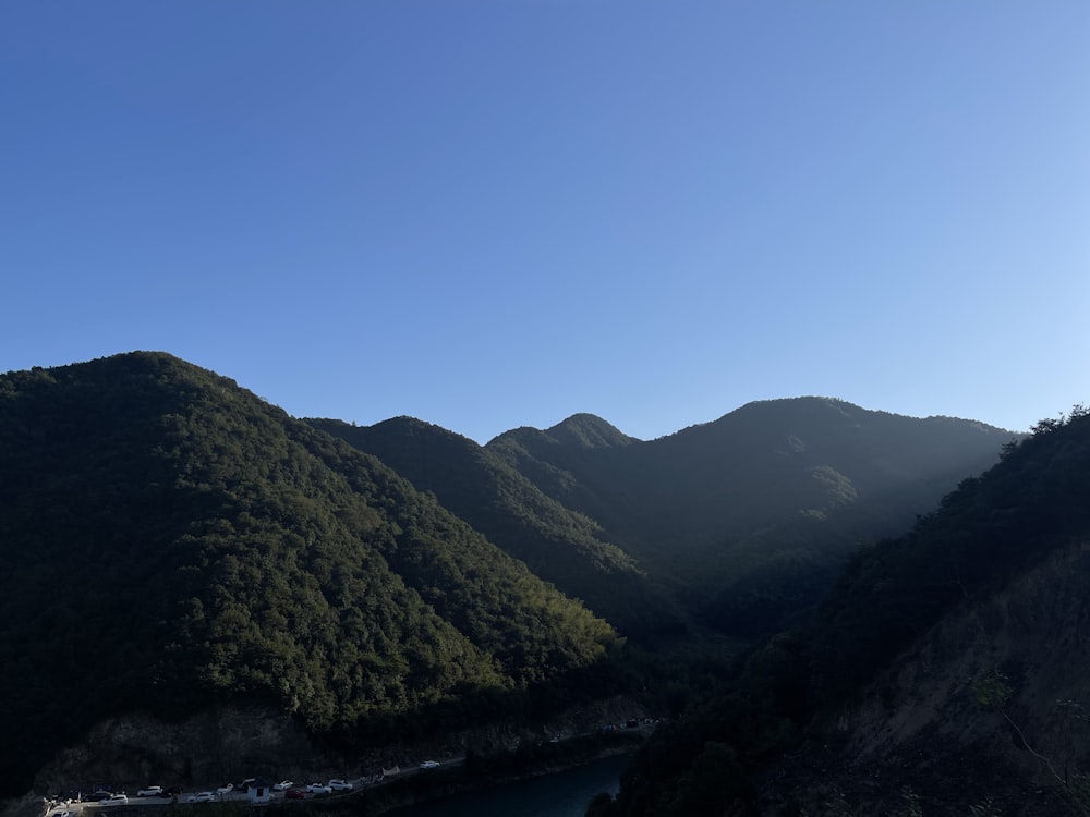 a view of a mountain range with a body of water in the foreground