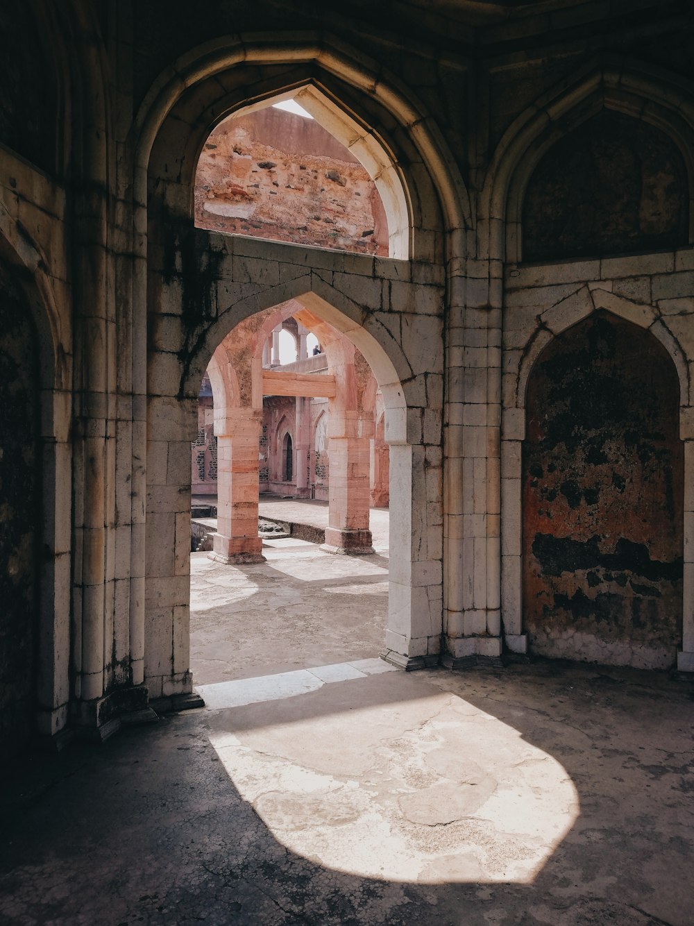 an archway in a building with a stone floor