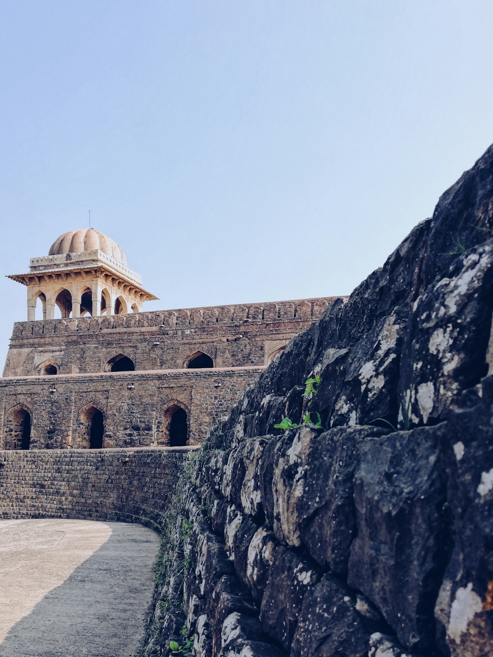 a stone wall with a white dome on top of it