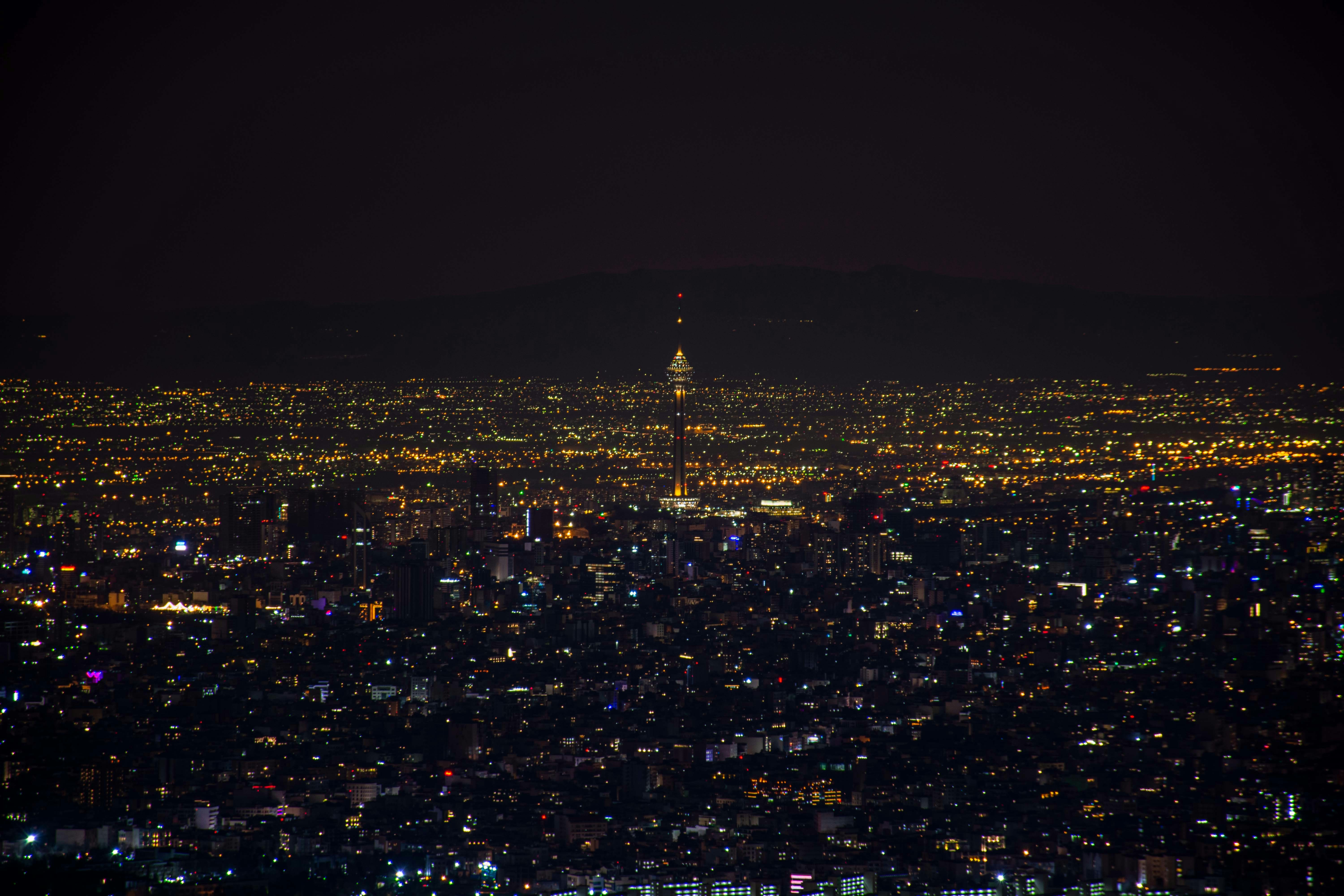 a view of a city at night from the top of a hill