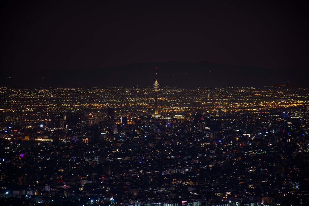 a view of a city at night from the top of a hill