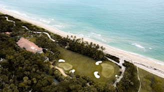 an aerial view of a golf course near the ocean