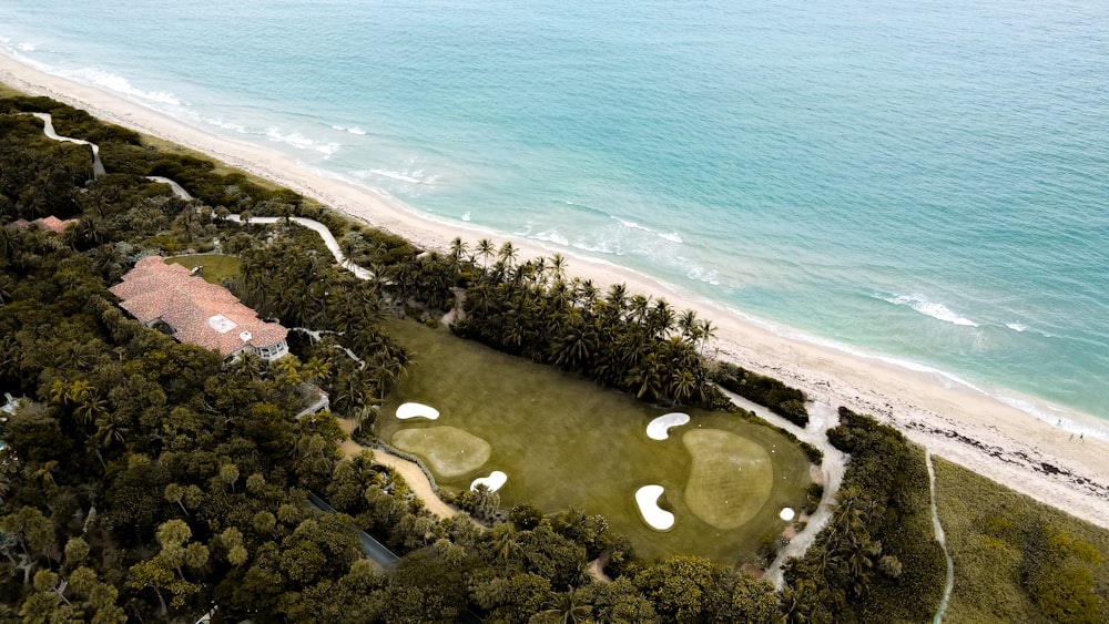 an aerial view of a golf course near the ocean