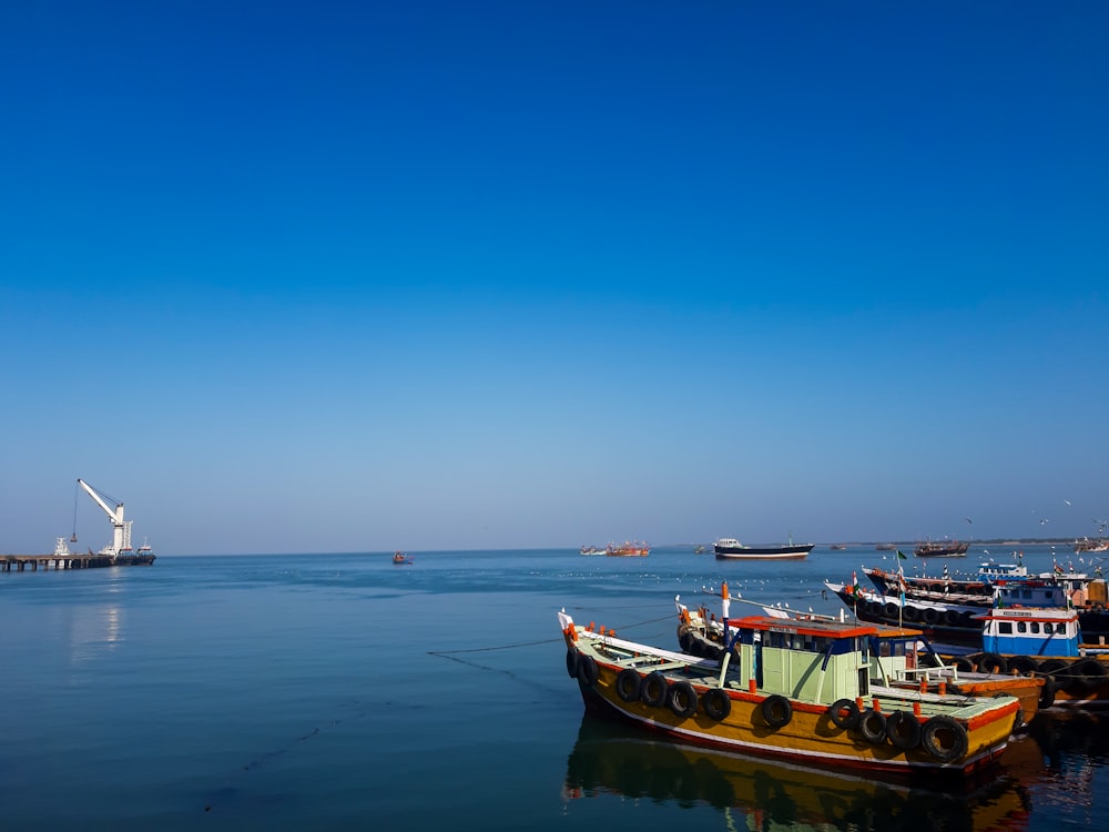 a group of boats floating on top of a body of water