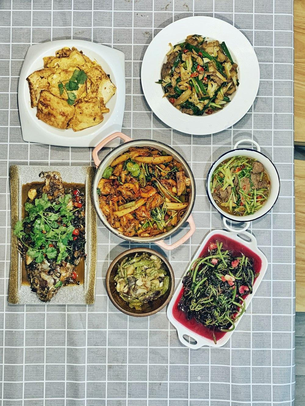 a table topped with plates and bowls of food