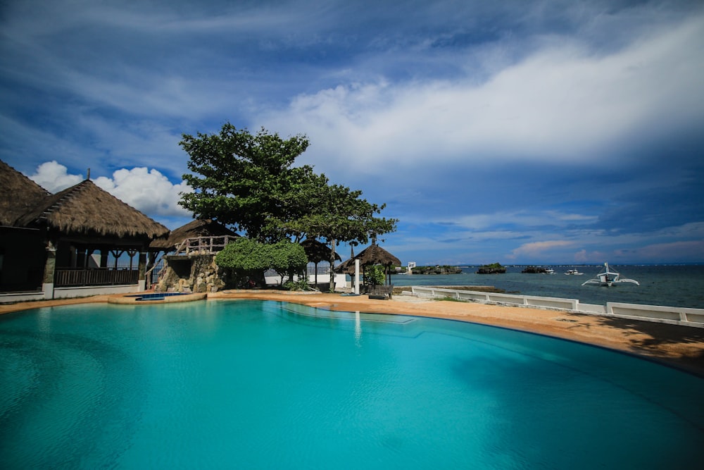 a large swimming pool next to a beach