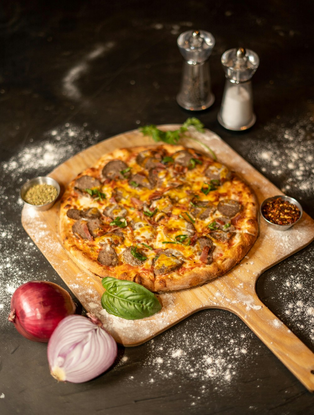 a pizza sitting on top of a wooden cutting board