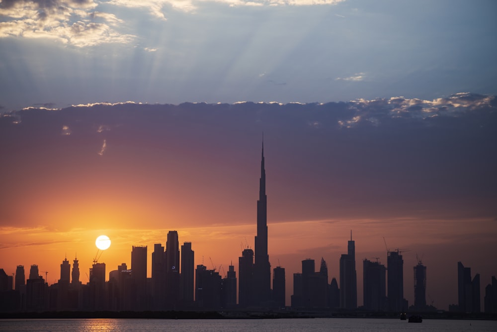 the sun is setting over a large city