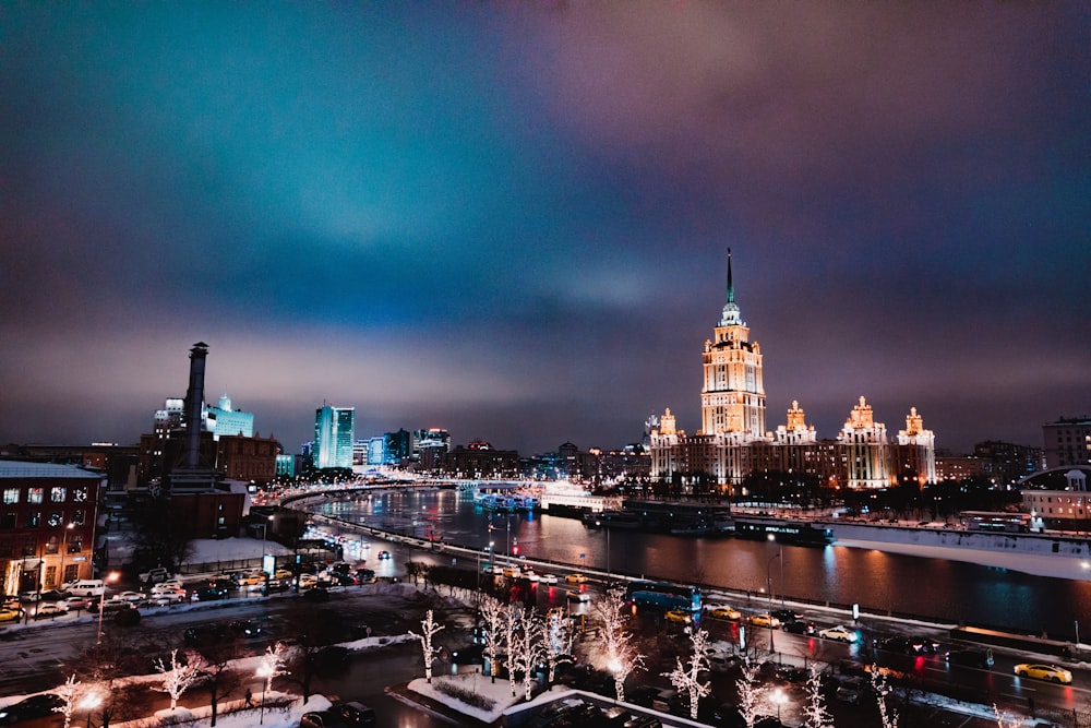 a night view of a city with a river and a bridge