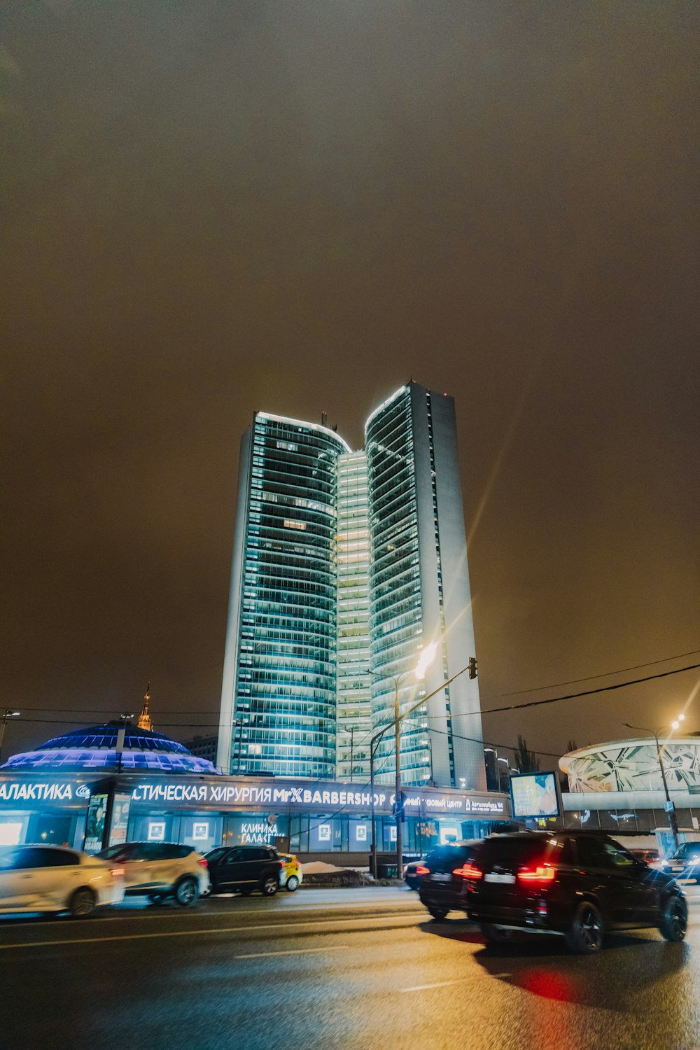 a very tall building sitting next to a busy street